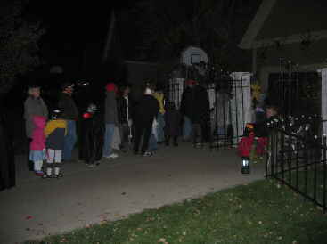 Trick or treaters visiting spookystreet.com walk through haunted house
